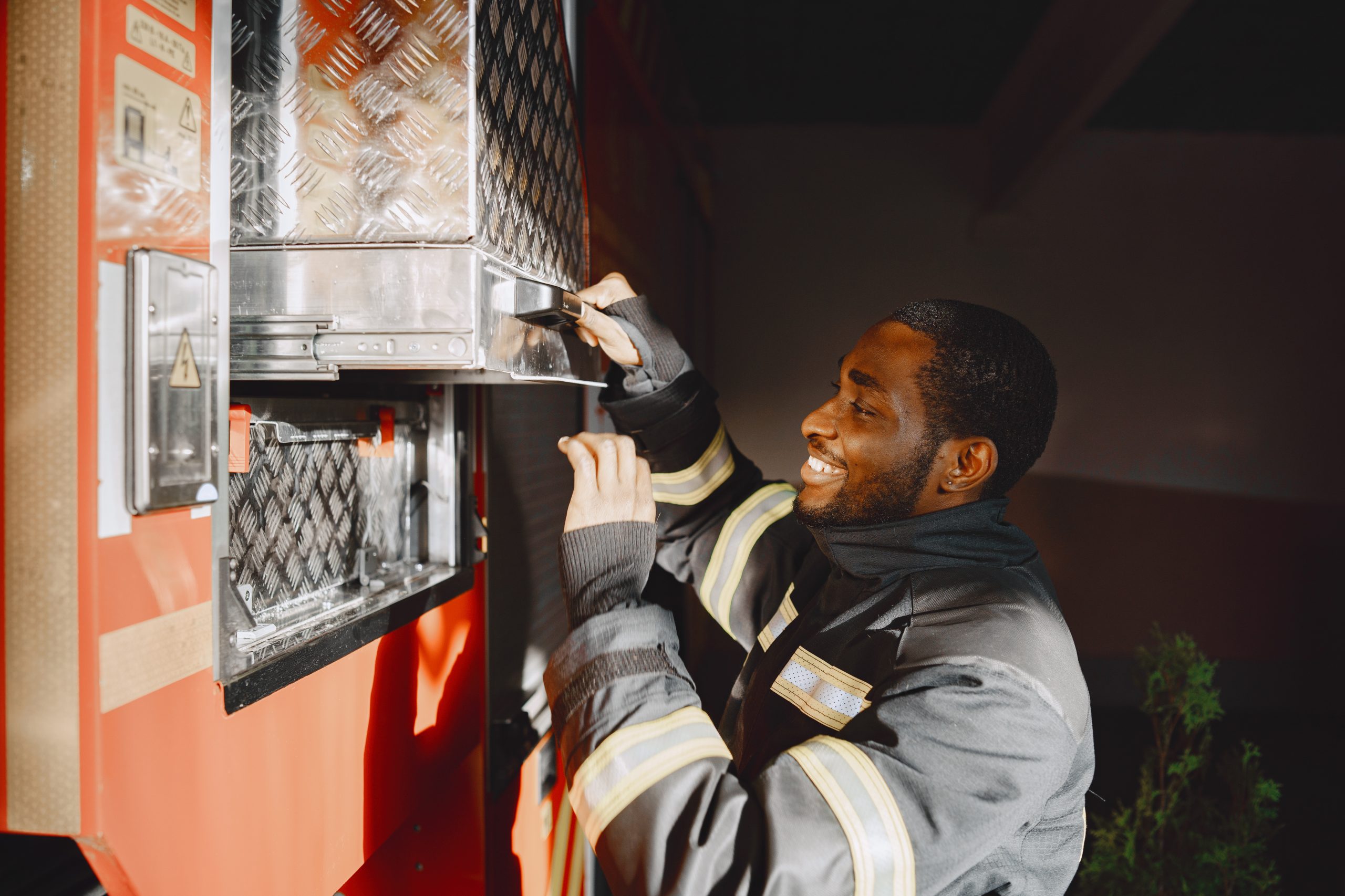 Arfican fireman in a uniform. Man prepare to work.